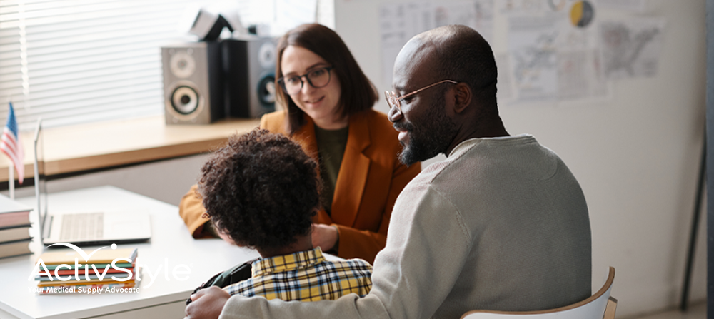 Parent and child talking to teacher at school